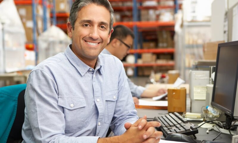 Businessman Working At Desk In Warehouse