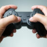 Video game console controller in gamer hands